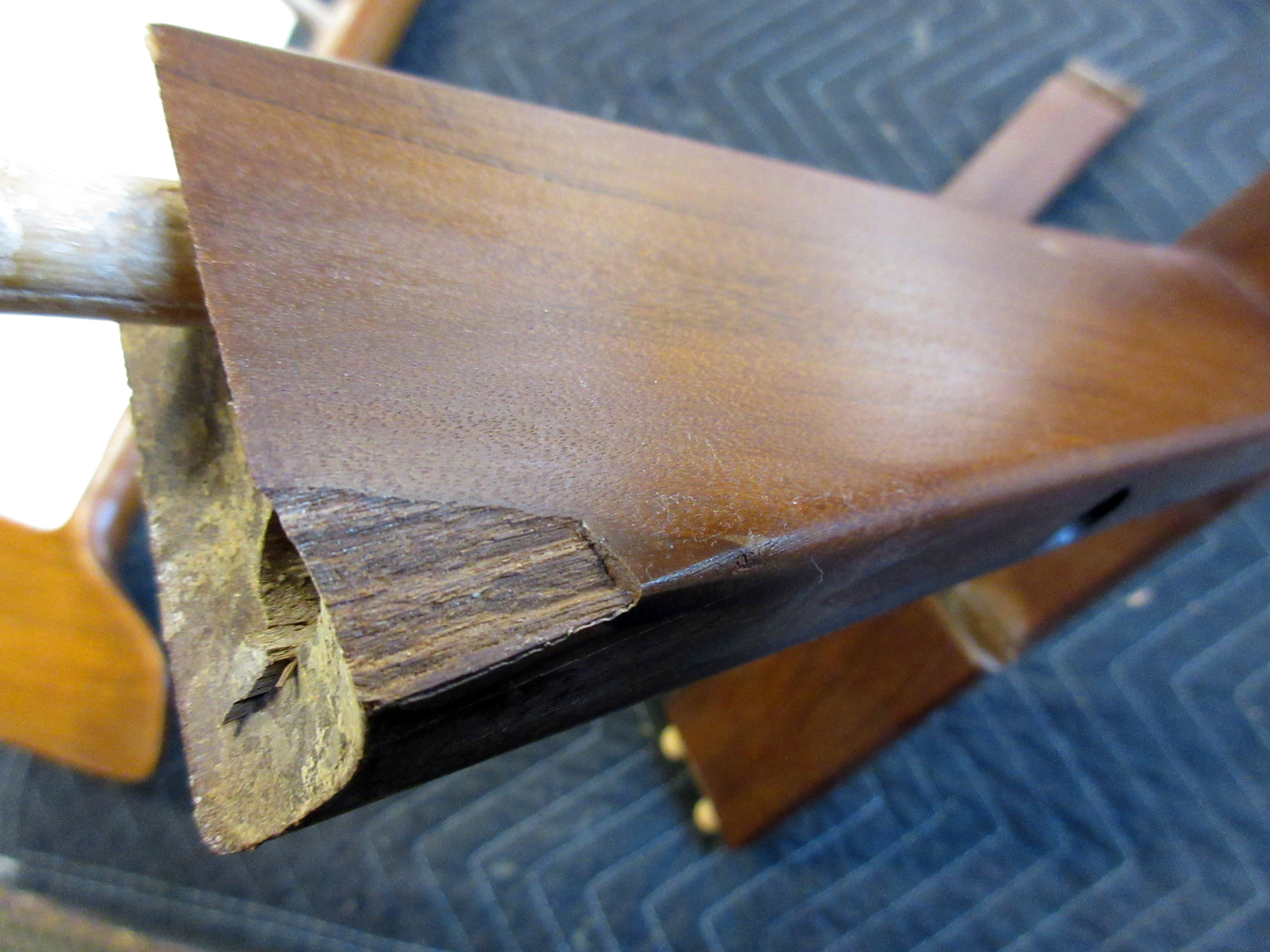 Danish teak chair disassembled for regluing - dutchman repair in progress